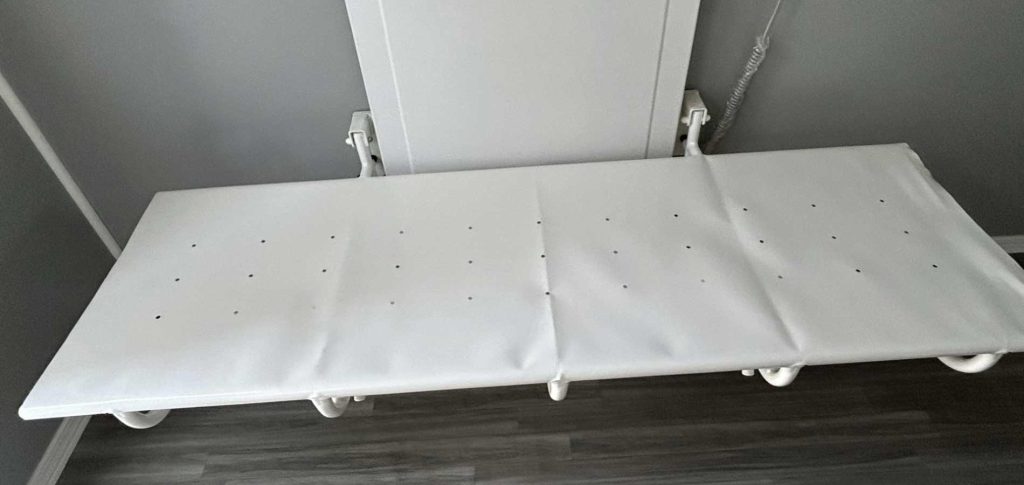 Adult changing table in a utility-style trailer with a single bathroom