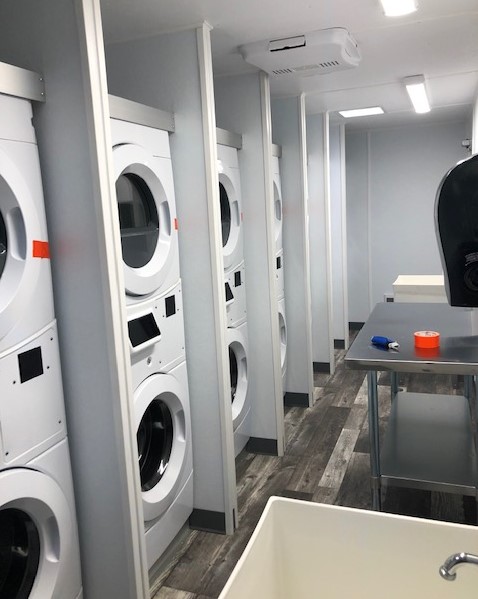 NRT mobile laundry trailer set up on site for crew laundry service